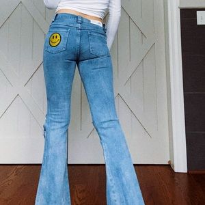 Delia’s bell bottom smiley patch jeans